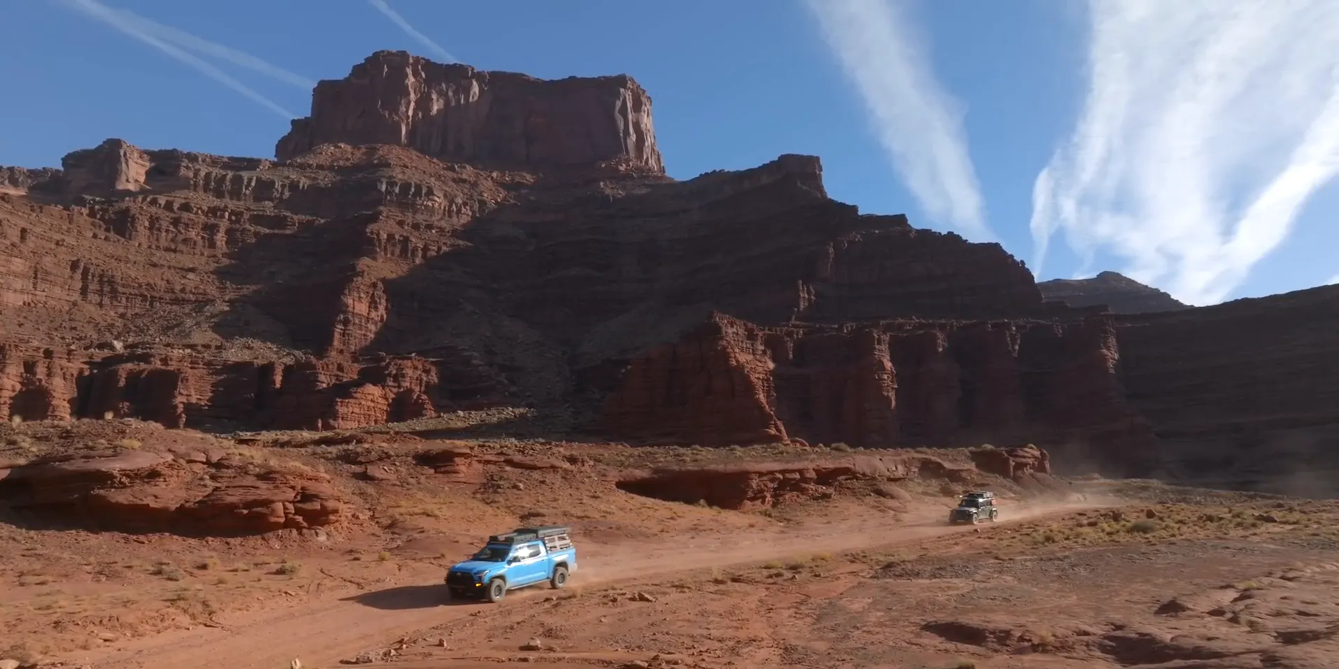 Expansive Utah red rock landscape with trails winding through badlands and mesas