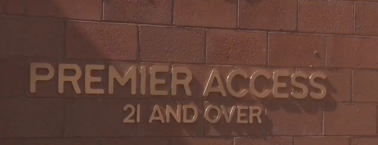 Premier access world pools with curated mineral features and food service in the background