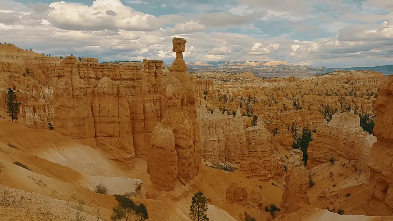 Bryce Canyon hoodoos with a tall capped hoodoo and panoramic amphitheater