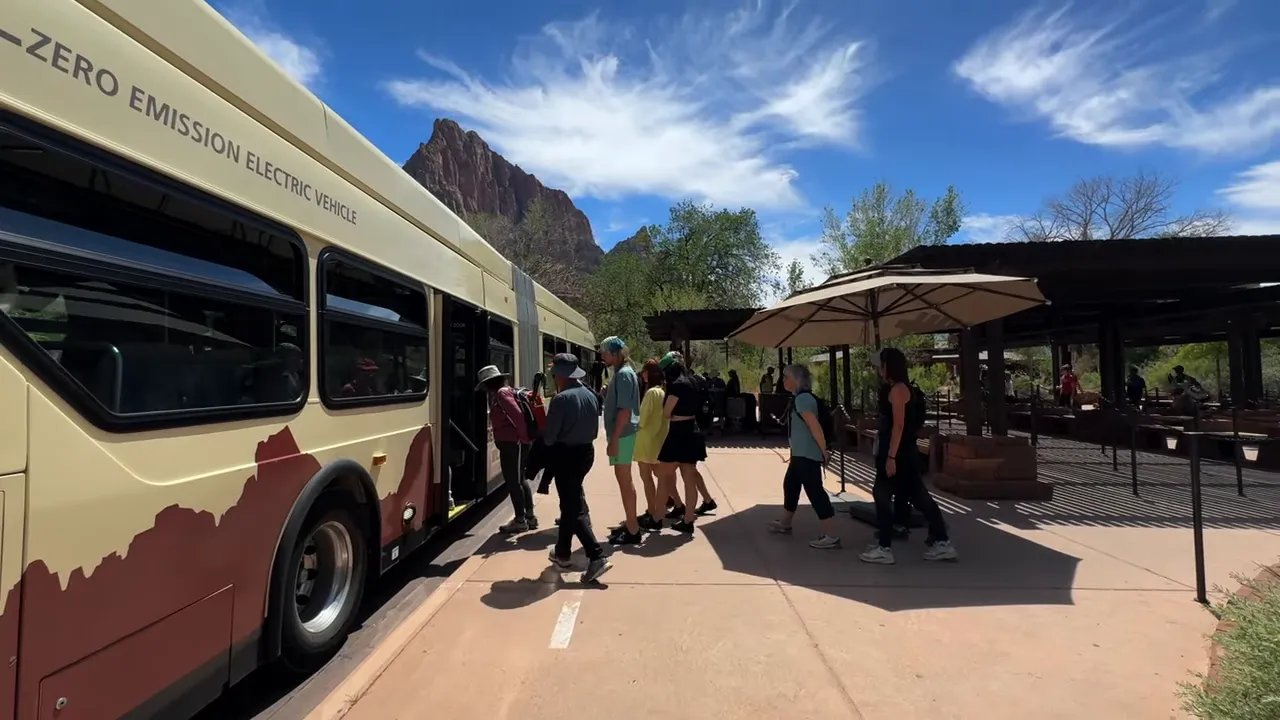 Passengers boarding a Zion Canyon shuttle at the visitor center loading area