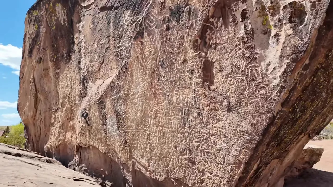 Broad view of the petroglyph-covered sandstone boulder at Petroglyph Park near downtown St. George