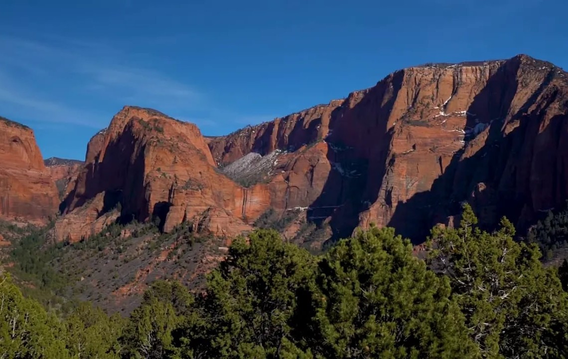 Red rock mountains with pine-covered valley near St. George, Utah