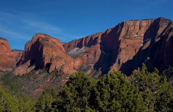 Red rock mountains with pine-covered valley near St. George, Utah